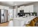 Modern kitchen featuring white cabinets, stainless steel appliances, and a breakfast bar, perfect for culinary enthusiasts at 673 N Tempe St, Aurora, CO 80018