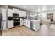 Bright and modern kitchen featuring stainless steel appliances and sleek white cabinetry, creating a welcoming and functional space at 673 N Tempe St, Aurora, CO 80018
