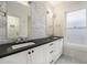 Bathroom featuring dual sinks, dark countertops, marble backsplash and tiling at 595 N Lafayette St, Denver, CO 80218