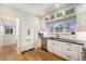 Bright and airy kitchen with white cabinetry, stainless steel appliances, and hardwood flooring at 595 N Lafayette St, Denver, CO 80218