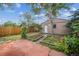 Backyard featuring garden beds, a patio, a shed, and mature trees at 3024 W Denver Pl, Denver, CO 80211