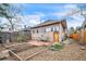 Spacious backyard offering potential for gardening and outdoor entertaining with established garden beds and a patio at 3024 W Denver Pl, Denver, CO 80211