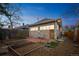 Backyard with garden beds, a patio, and exterior of the home at 3024 W Denver Pl, Denver, CO 80211