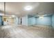 Spacious basement with carpet flooring, ample lighting, and a utility area at 3024 W Denver Pl, Denver, CO 80211