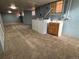 A spacious, carpeted basement laundry area with a sink and blue walls at 3024 W Denver Pl, Denver, CO 80211