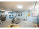 Finished basement offers a spacious rec area with movies posters on the walls at 3024 W Denver Pl, Denver, CO 80211
