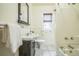 This bathroom features a pedestal sink, tiled floors, and a classic design with neutral tones at 3024 W Denver Pl, Denver, CO 80211