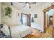 Bedroom with hardwood floors, hanging plants and ceiling fan offers a cozy atmosphere at 3024 W Denver Pl, Denver, CO 80211