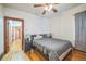 Bedroom featuring wood floors, neutral walls, ceiling fan and natural wood trim at 3024 W Denver Pl, Denver, CO 80211