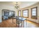 Open-concept dining area adjacent to living room, showcasing hardwood floors and natural light at 3024 W Denver Pl, Denver, CO 80211