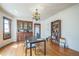 Dining room has vintage light fixture, built-in china cabinet, wood floors and wall-mounted air conditioner at 3024 W Denver Pl, Denver, CO 80211