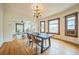 A well-lit dining room with hardwood flooring adjacent to the living room at 3024 W Denver Pl, Denver, CO 80211