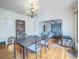 Spacious dining room with hardwood floors, vintage light fixture and archway entrance to living room at 3024 W Denver Pl, Denver, CO 80211