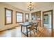 Traditional dining room with hardwood floors, a wooden table, and a vintage-style chandelier at 3024 W Denver Pl, Denver, CO 80211