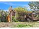 All brick exterior with covered porch, well-maintained lawn, and mature landscaping provide a welcoming first impression at 3024 W Denver Pl, Denver, CO 80211