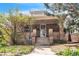 Charming brick home featuring a covered porch, concrete steps and beautiful landscaping at 3024 W Denver Pl, Denver, CO 80211