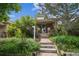 Charming brick home with lush landscaping, front steps, and clear house number at 3024 W Denver Pl, Denver, CO 80211