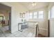 Bright hallway with tiled floor, a table by the stairs, and a large window at 3024 W Denver Pl, Denver, CO 80211