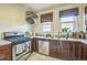 Traditional kitchen with stainless steel appliances, plenty of countertop space and tile floors at 3024 W Denver Pl, Denver, CO 80211