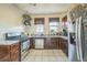 Traditional kitchen with stainless steel appliances, plenty of countertop space and tile floors at 3024 W Denver Pl, Denver, CO 80211