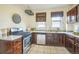 Cozy kitchen with stainless steel appliances, white countertops and tile flooring at 3024 W Denver Pl, Denver, CO 80211