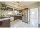 Traditional kitchen with stainless steel appliances, plenty of countertop space and tile floors at 3024 W Denver Pl, Denver, CO 80211
