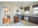 Well-lit kitchen with stainless steel appliances, white countertops, and an open doorway to the dining area at 3024 W Denver Pl, Denver, CO 80211