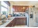 Traditional kitchen with stainless steel appliances, plenty of countertop space and tile floors at 3024 W Denver Pl, Denver, CO 80211