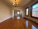 Spacious living room showcases hardwood floors, a decorative chandelier, and an arched entry to the den at 3024 W Denver Pl, Denver, CO 80211