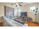 Cozy living room features a comfortable gray couch, ceiling fan and hardwood flooring at 3024 W Denver Pl, Denver, CO 80211