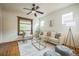 Inviting living room with hardwood floors, area rug, modern furniture and large windows at 3024 W Denver Pl, Denver, CO 80211