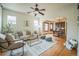 Bright living room boasts hardwood floors, ceiling fan, and easy access to the dining room at 3024 W Denver Pl, Denver, CO 80211