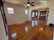 Bright living room with hardwood floors, a ceiling fan, and a view of the dining room at 3024 W Denver Pl, Denver, CO 80211