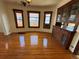 Charming living room with gleaming hardwood floors, vintage built-in cabinet and three windows at 3024 W Denver Pl, Denver, CO 80211