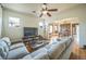 Comfortable living room featuring hardwood floors, a large TV and open to the dining room at 3024 W Denver Pl, Denver, CO 80211