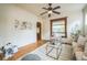 Cozy living room features hardwood floors, rug, modern furniture, and natural light from windows at 3024 W Denver Pl, Denver, CO 80211