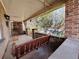Covered front porch with brick accents and a porch swing at 3024 W Denver Pl, Denver, CO 80211