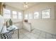 A sun room featuring bright, natural lighting and white tiled floors at 3024 W Denver Pl, Denver, CO 80211