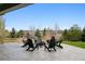 Outdoor patio with fire pit surrounded by mature trees creates a cozy backyard retreat for outdoor relaxation at 5310 Craftsman Dr, Parker, CO 80134