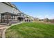 A beautiful backyard with green lawn, patio, fire pit and hot tub for outdoor entertaining at 5310 Craftsman Dr, Parker, CO 80134