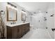 Beautifully renovated bathroom with a double vanity, marble countertop, and walk-in glass shower at 5310 Craftsman Dr, Parker, CO 80134