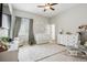 Bright Bedroom features white furniture, a crib, a glider, and dinosaur-themed wall art at 5310 Craftsman Dr, Parker, CO 80134