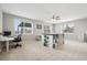Bright bonus room featuring three windows, a ceiling fan, and a crafting area at 5310 Craftsman Dr, Parker, CO 80134
