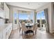 Bright dining area with bay windows, sliding doors, and a six-chair round dining table at 5310 Craftsman Dr, Parker, CO 80134
