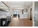 Inviting foyer featuring wood floors, arched doorways, and contemporary decor at 5310 Craftsman Dr, Parker, CO 80134