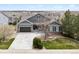 Charming gray home with a well-manicured lawn and a two-car garage in a peaceful neighborhood at 5310 Craftsman Dr, Parker, CO 80134