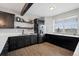 Stylish kitchen with dark cabinetry, stainless steel appliances, wine rack, and white countertops at 5310 Craftsman Dr, Parker, CO 80134
