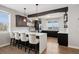 Beautiful kitchen boasts dark cabinetry, white countertops, a large island, and hardwood floors at 5310 Craftsman Dr, Parker, CO 80134