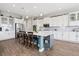 Modern kitchen with white cabinets, stainless steel appliances, and an island with seating at 5310 Craftsman Dr, Parker, CO 80134