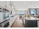 Well-lit kitchen with stainless steel appliances, a spacious island, and an adjacent eat-in nook at 5310 Craftsman Dr, Parker, CO 80134
